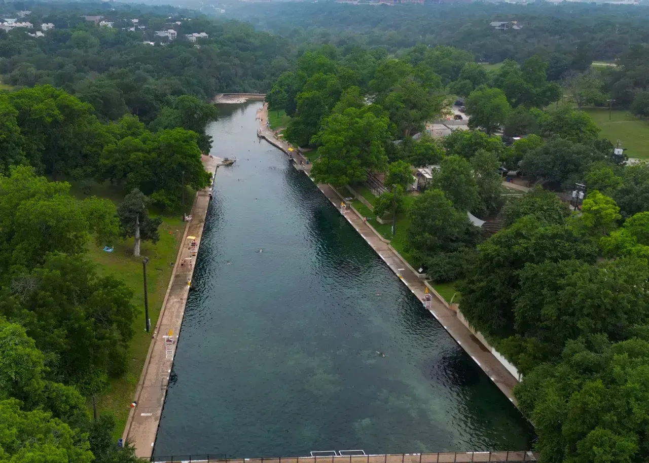 Aerial view of Barton Springs Pool surrounded by trees