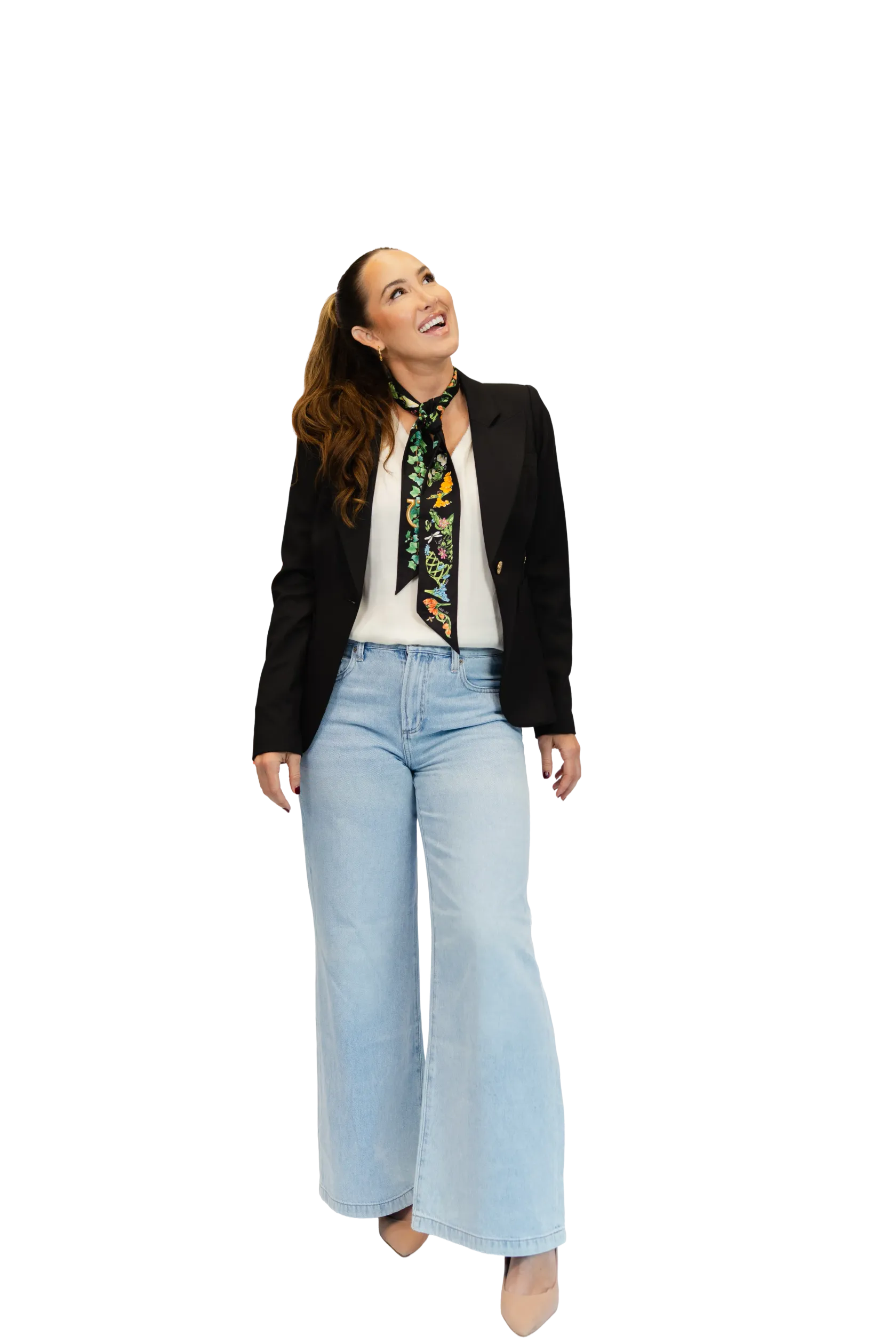 Codie Sanchez in a black blazer and scarf, looking up and smiling