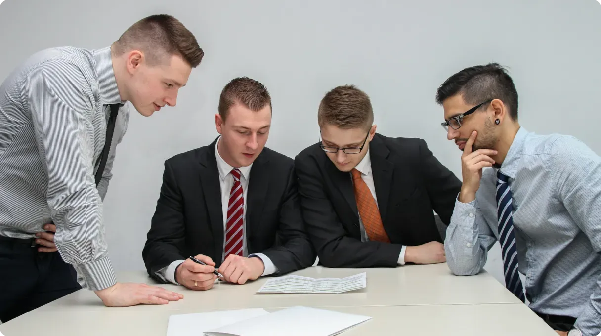 Four Men Reviewing Documents