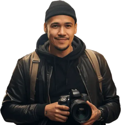 Smiling man in a beanie and leather jacket holding a camera