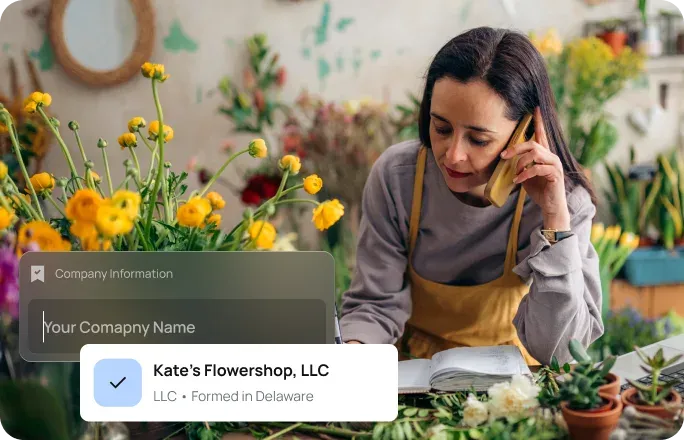 Florist taking a phone call while working on arrangements in her shop