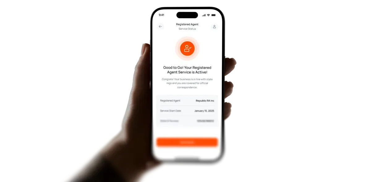 Hand holding a phone showing an active Registered Agent service