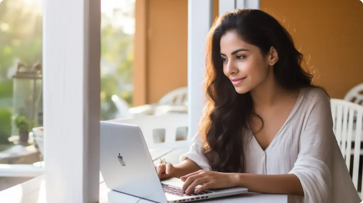 Woman Sitting And Working On Macbook