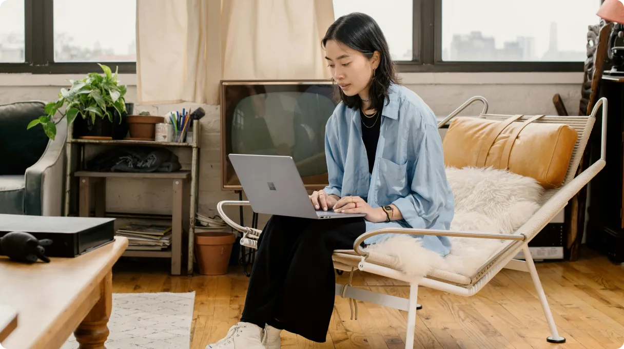 A woman working remotely on a laptop.