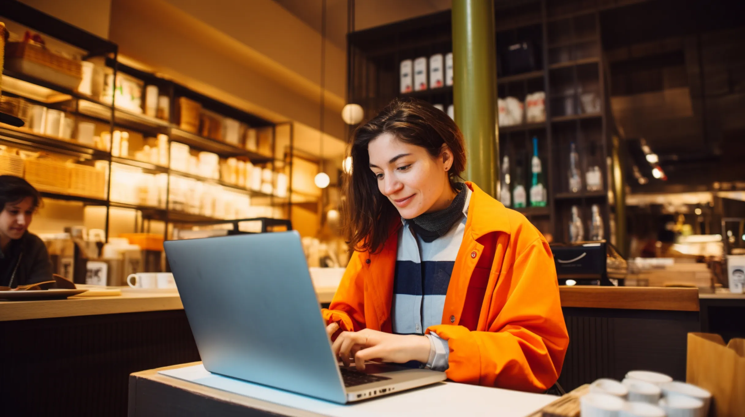 Woman working on a laptop in an office space