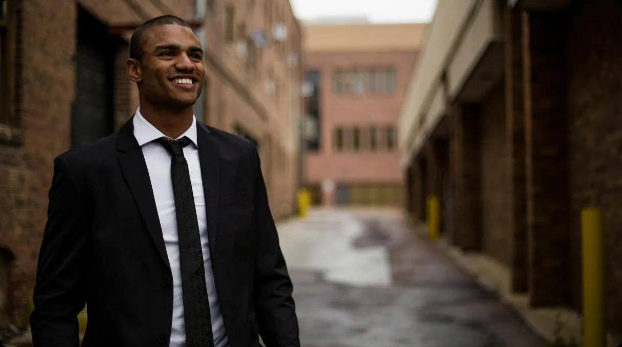 Elegant man in a suit standing in an alleyway