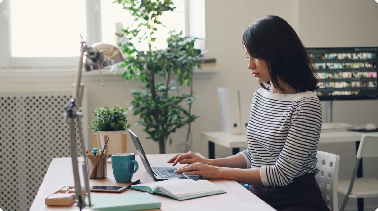 A phone sitting on top of a table next to a book