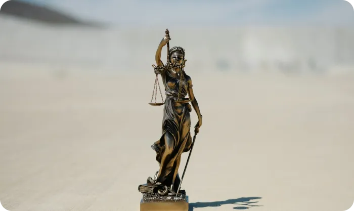 Statue of a lady justice holding a scale