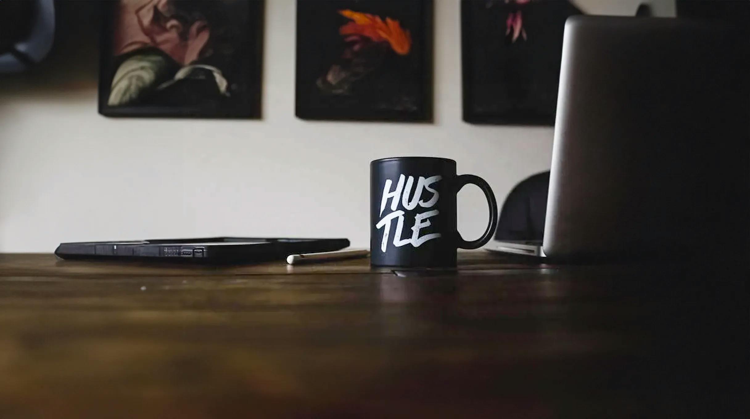 Cup standing on a desk with a "hustle" written on it