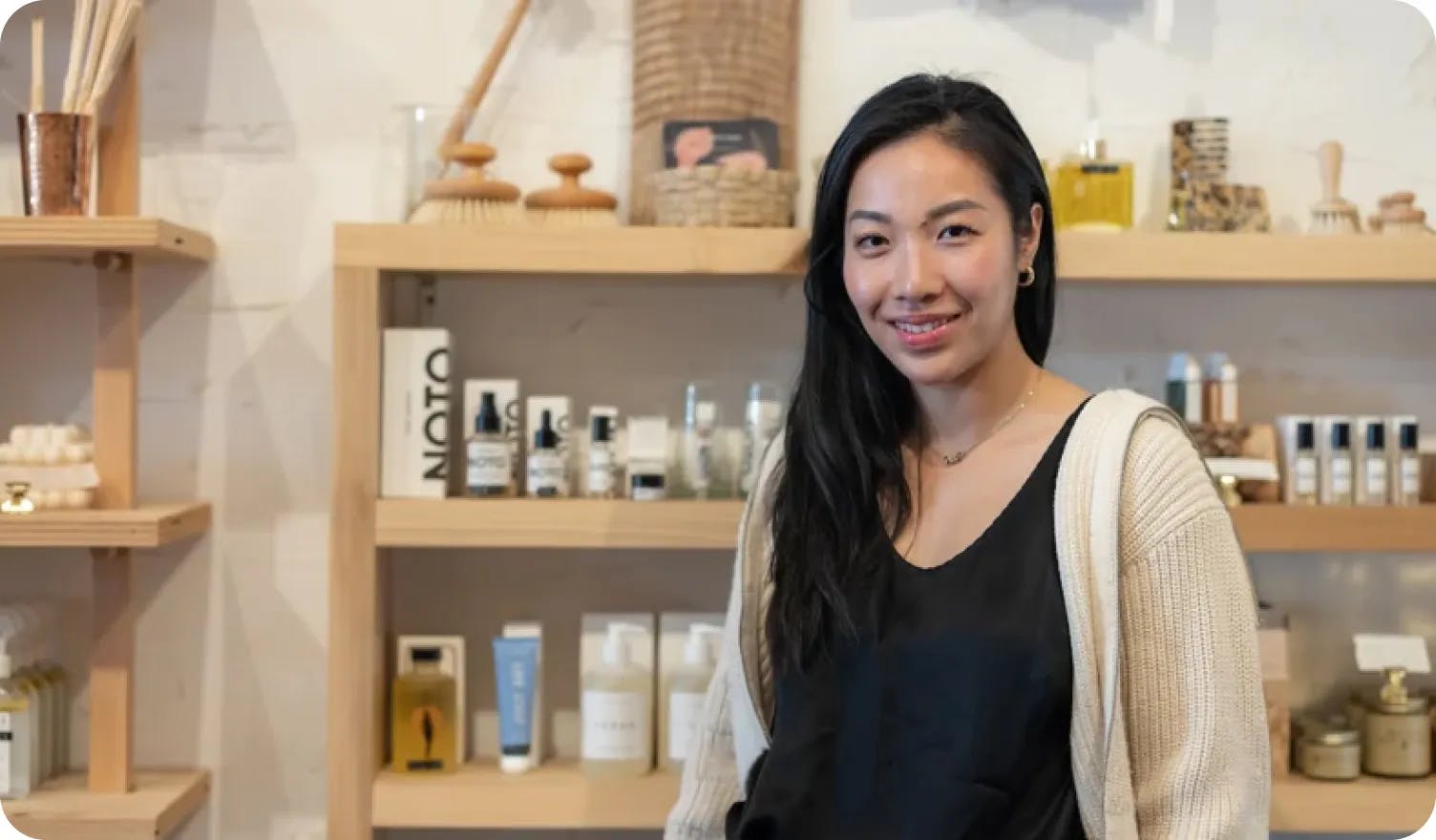 Founder Aoxue Tang with July Sky products in the background.