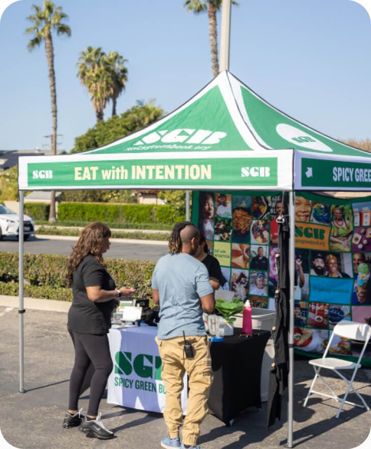 People standing at the stand of Spicy Green Book