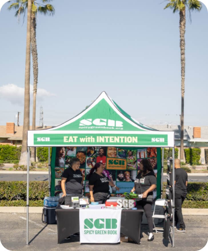 A stand of Spicy Green Book with 3 people inside