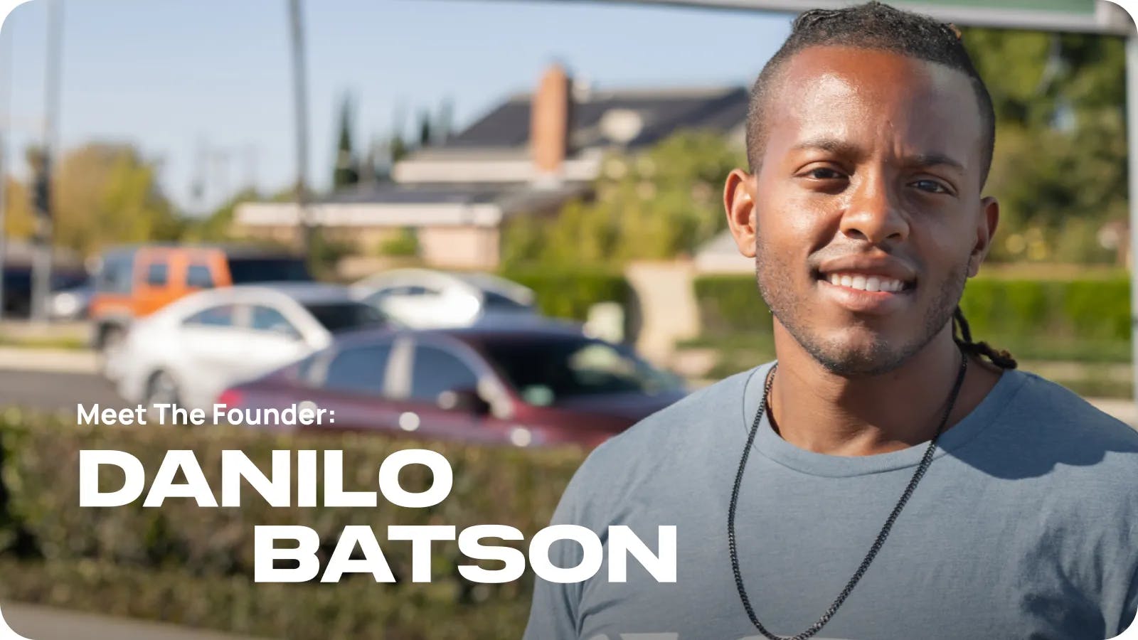 Meet the founder: Danilo Batson. Danilo Watson with cars in the background