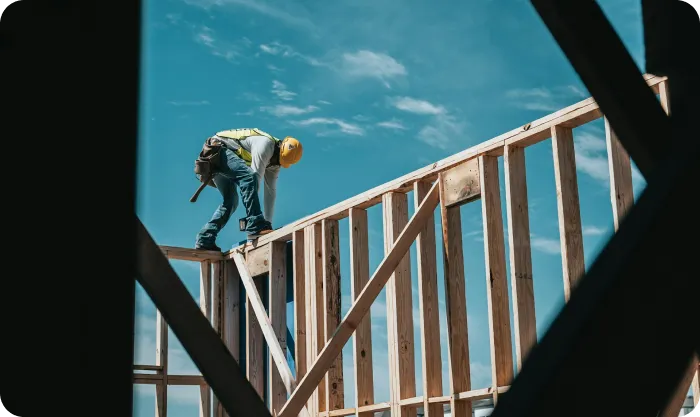 man-in-yellow-shirt-and-blue-denim-jeans-jumping-on-brown-wooden-railings