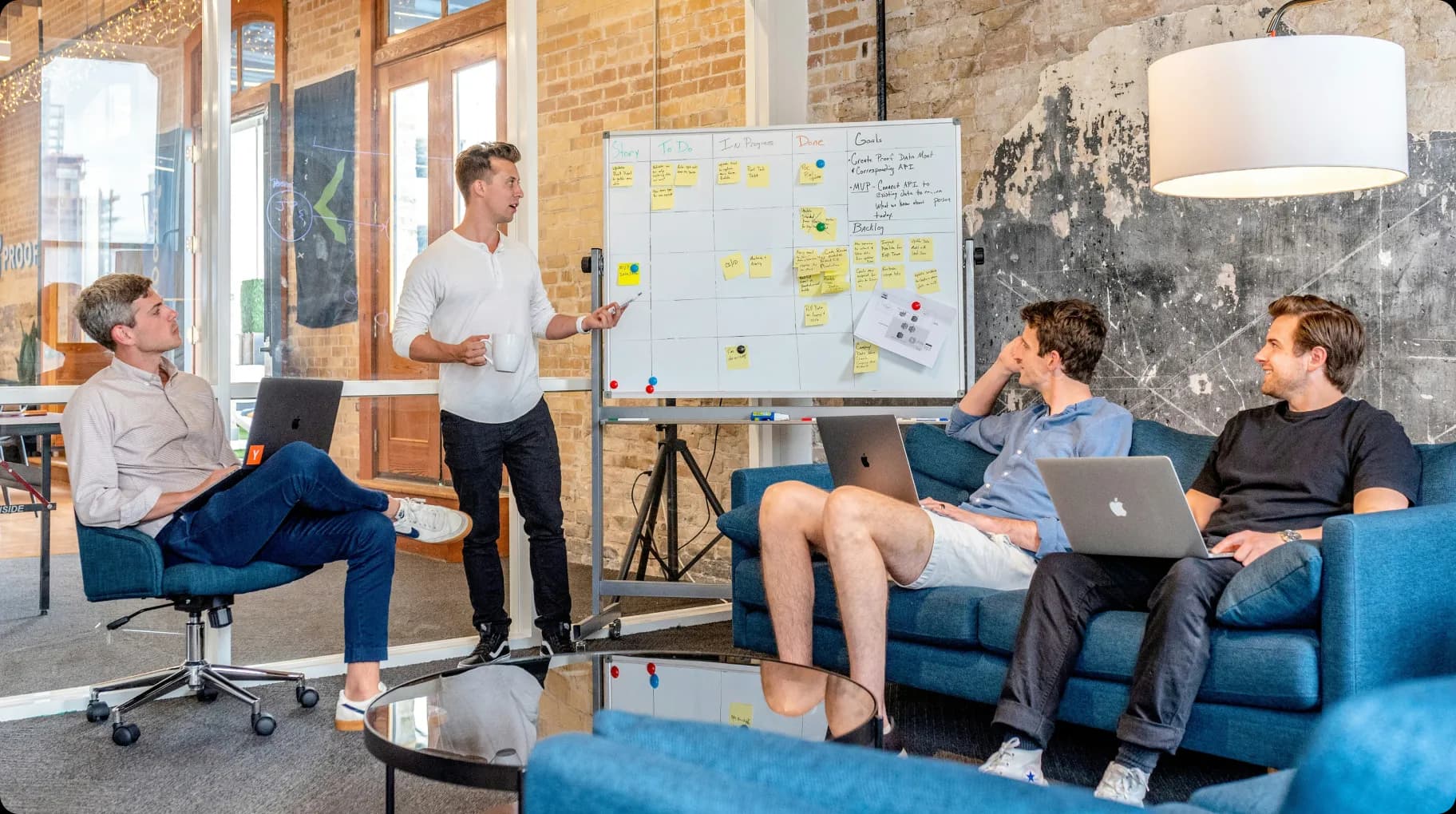 team-brainstorming-session-with-whiteboard-and-laptops