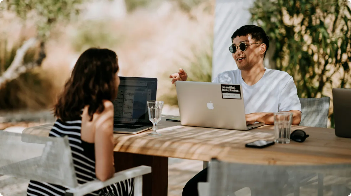 three-men-sitting-on-chair-beside-tables