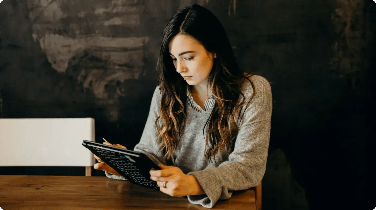 A Woman Working With A Tablet