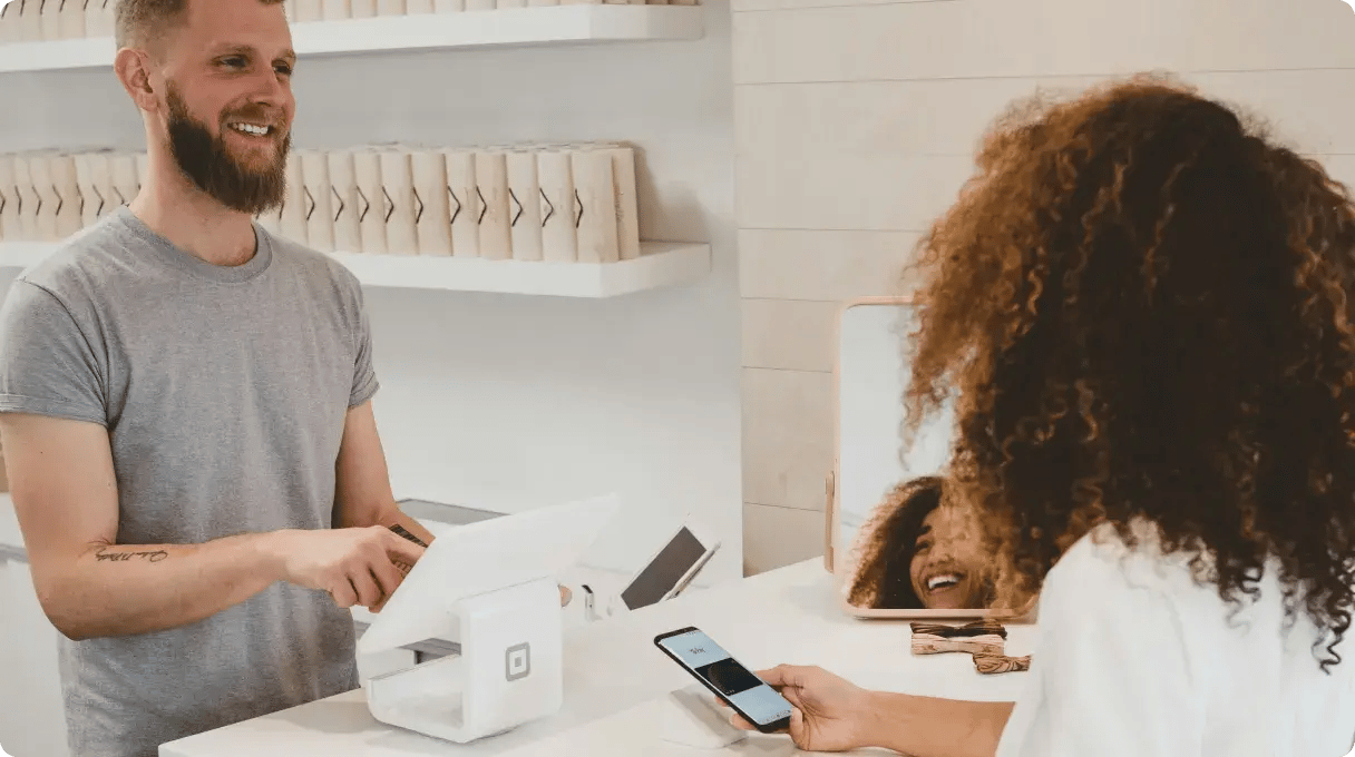 Two People Making A Purchase Transaction