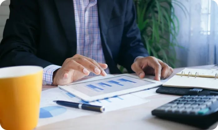 Person In Black Suit Holding Tablet