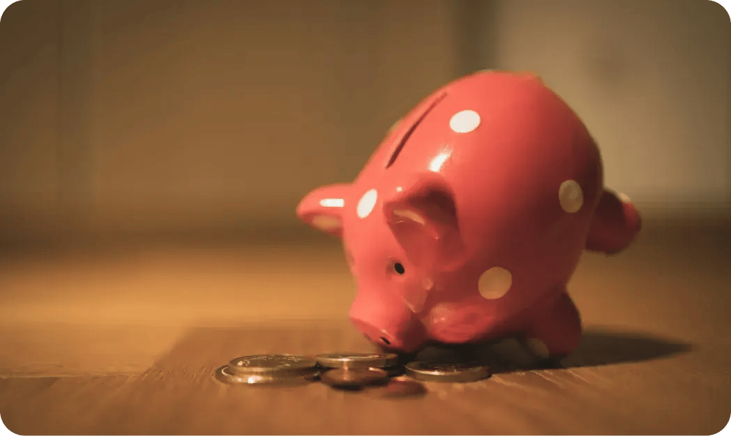 Pink Pig Coin Bank On Brown Wooden Table