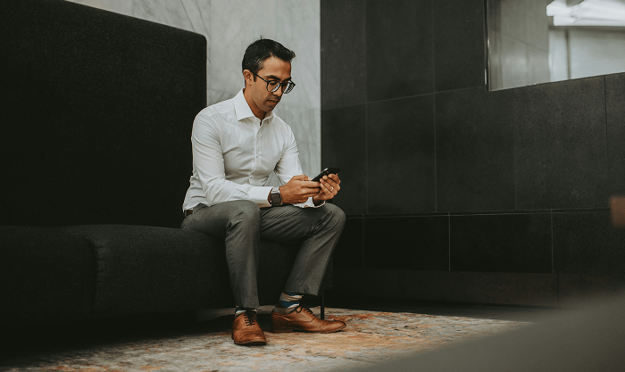 Confident solo founder researching non-equity funding options at home, surrounded by notebooks, legal documents, and a laptop displaying grant and business credit tools.