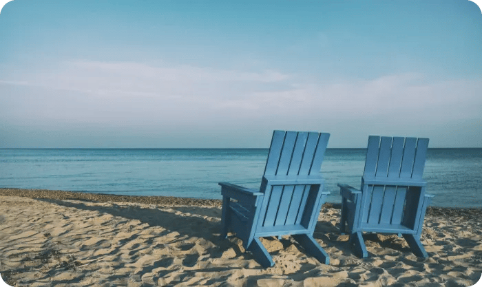 Two Wooden Chairs On Beach