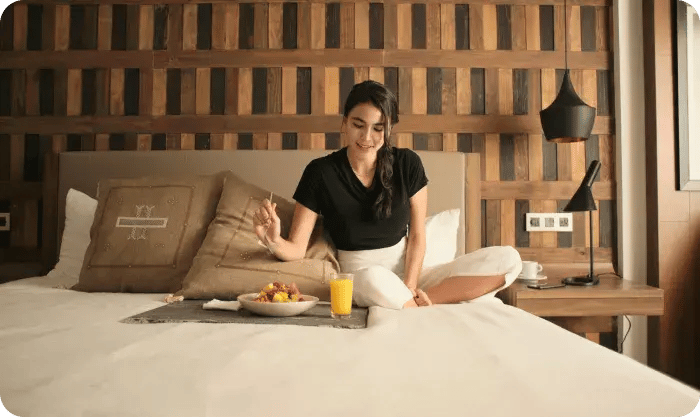 Woman Enjoying Breakfast In Cozy Hotel Room 1767032167