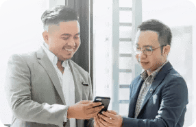 Business Meeting Two Men Sharing Information On Smartphone