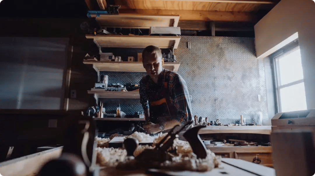 Carpenter At Work In Workshop