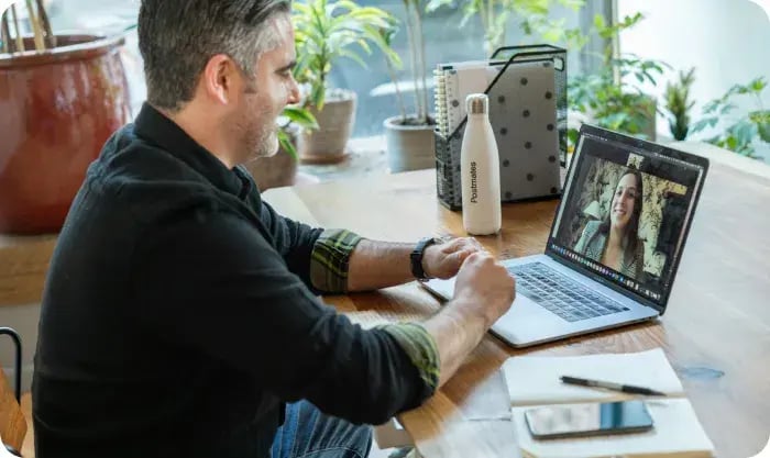 Man In Black Sweater Using Macbook Pro