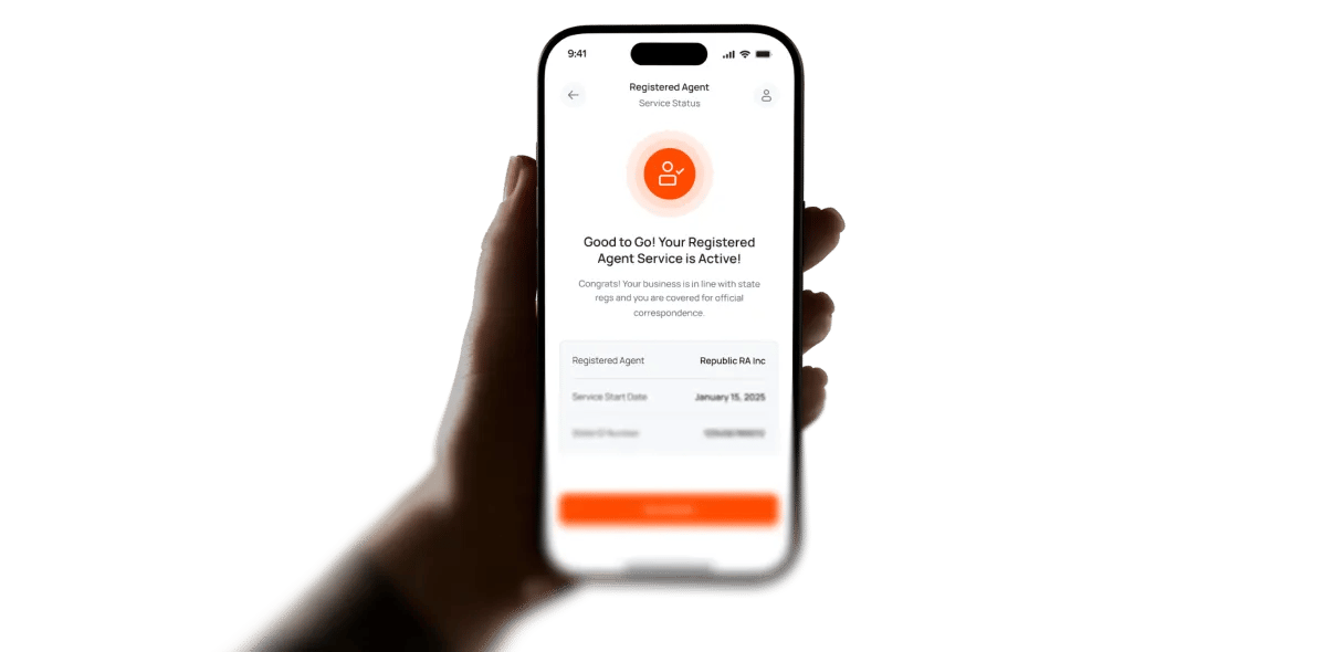 Hand holding a phone showing an active Registered Agent service.