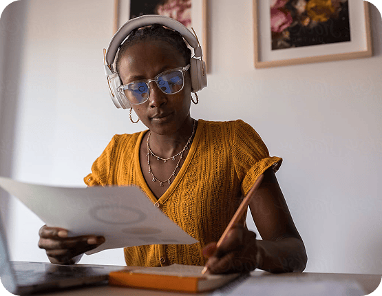 Woman Reviewing Documents Headphones