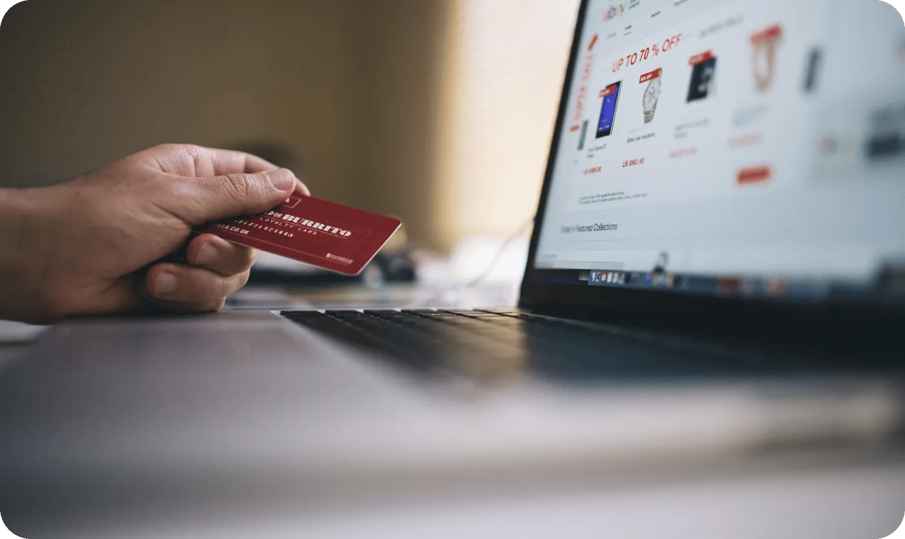 Person Using Laptop Computer Holding Card 2