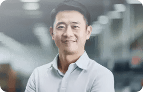 Smiling Industrial Professional In Modern Factory Environment