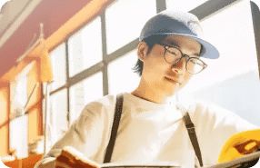Young Student Studying In Coffee Shop With Natural Light