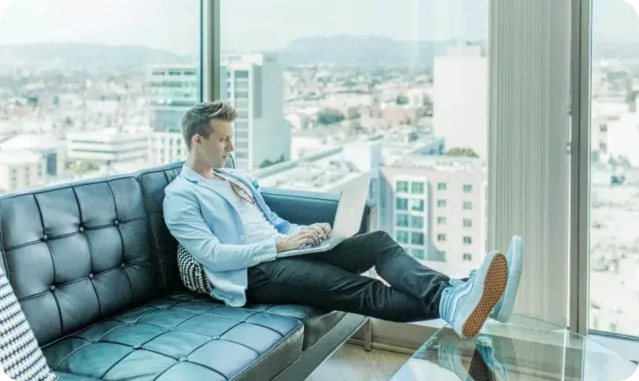 One man working on laptop by the window