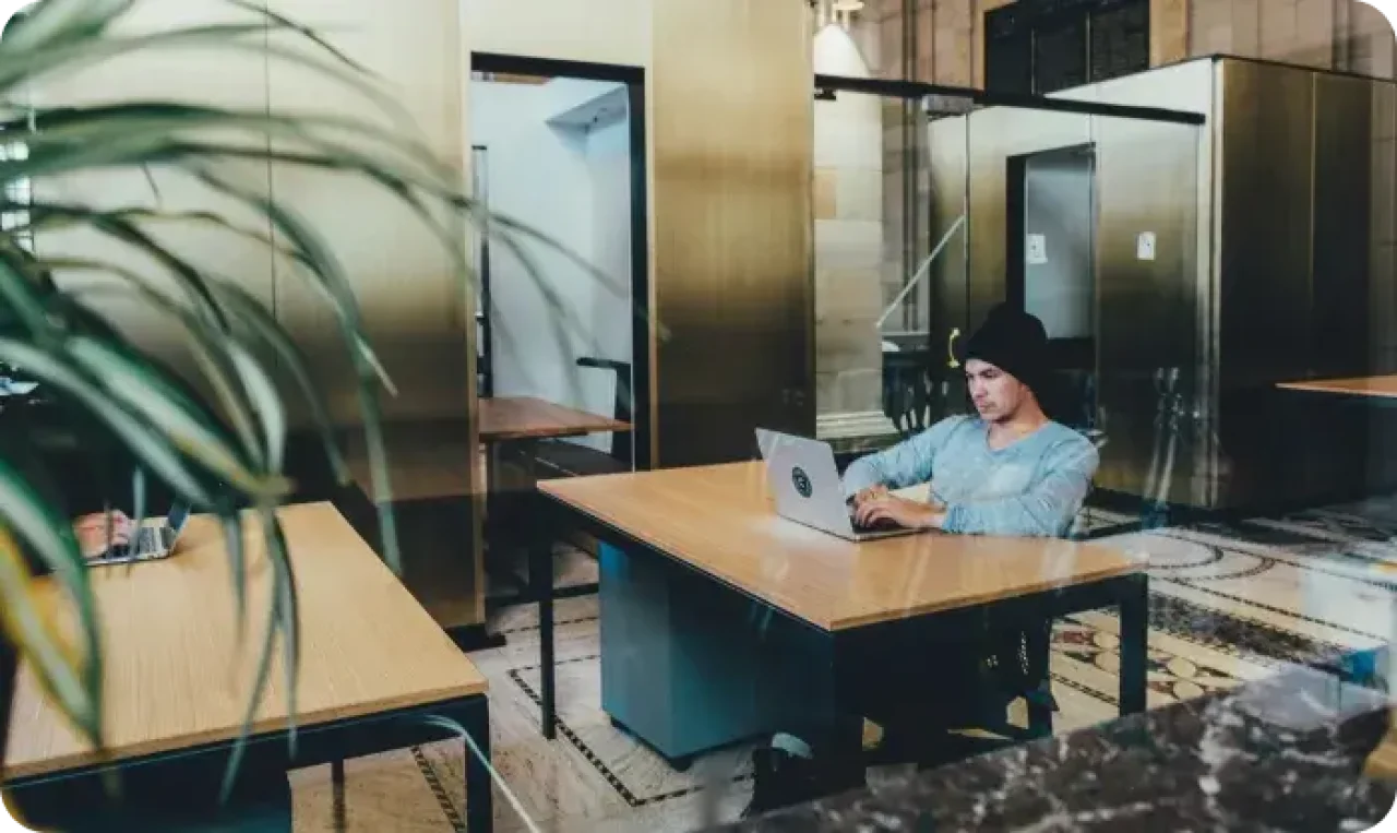 One man working on laptop in office