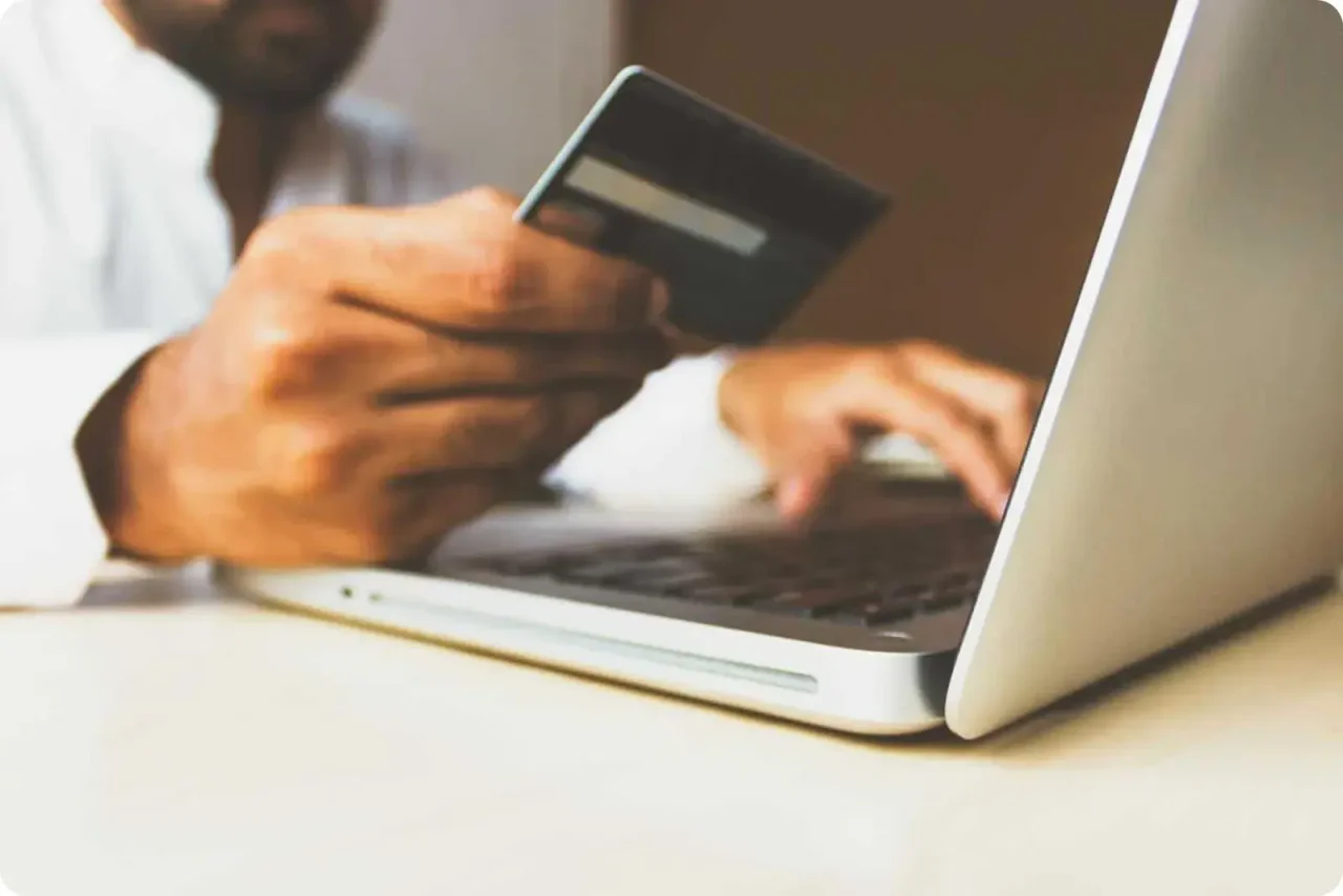 Person Paying Online With Credit Card And Laptop