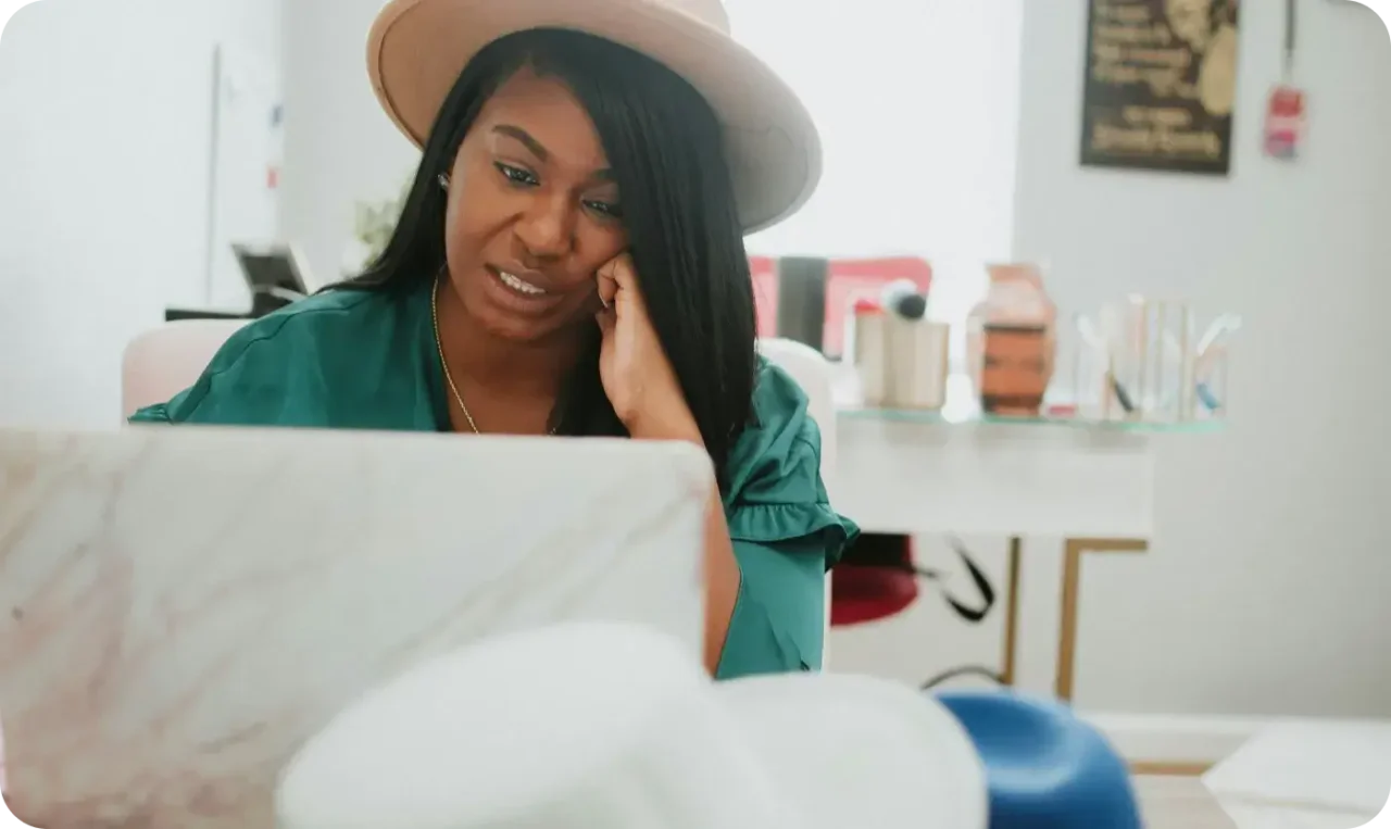 Woman Working On Laptop At Home Office Wearing Hat