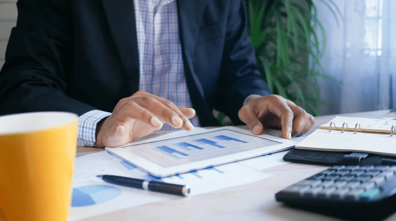 Entrepreneur weighing business compliance against cash flow decisions with charts and legal documents