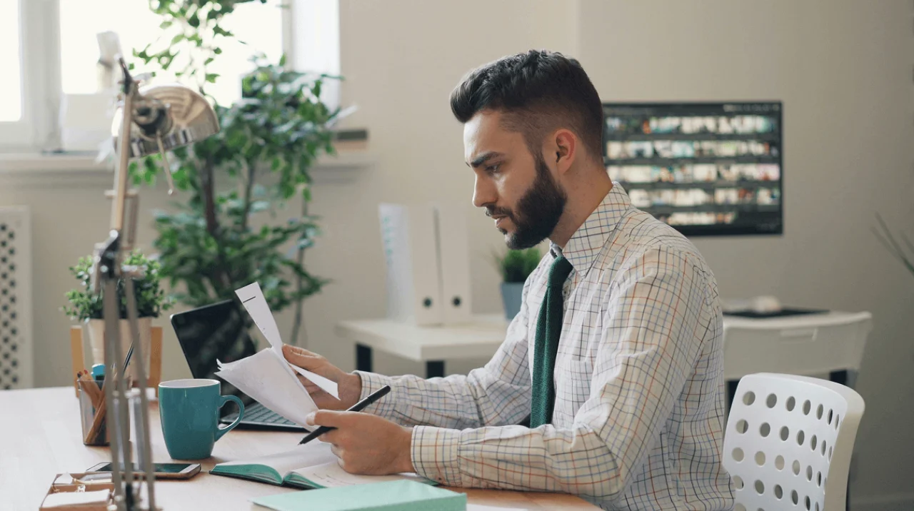 Business owner reviewing a contract with a highlighter, legal dictionary, and notes on the table