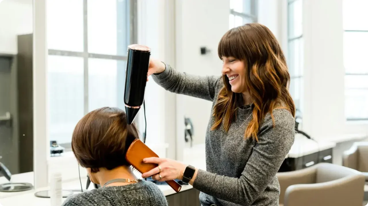 A woman hairdresser working on her client's hair