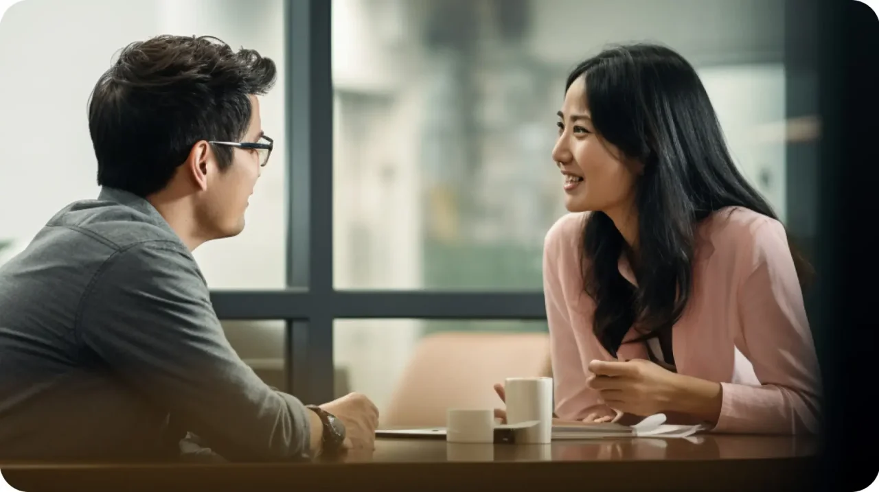 Two People Talking In Office Meeting