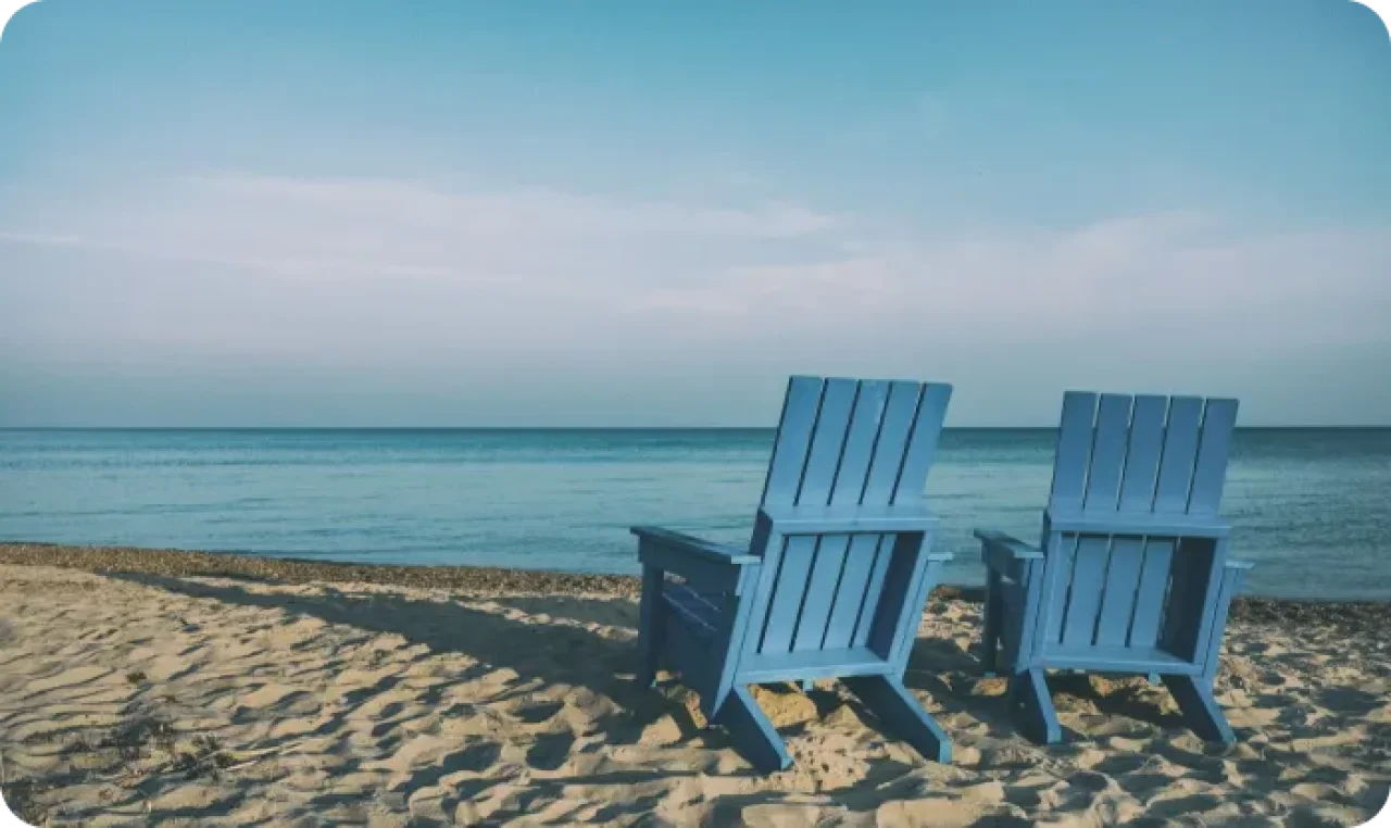 Two Wooden Chairs On Beach