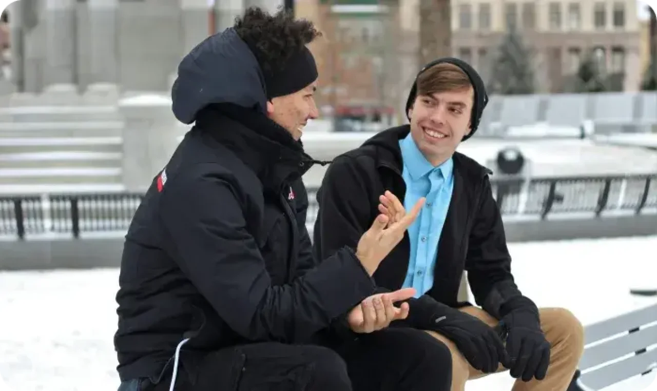 Two Men Talking Outdoors Winter Bench