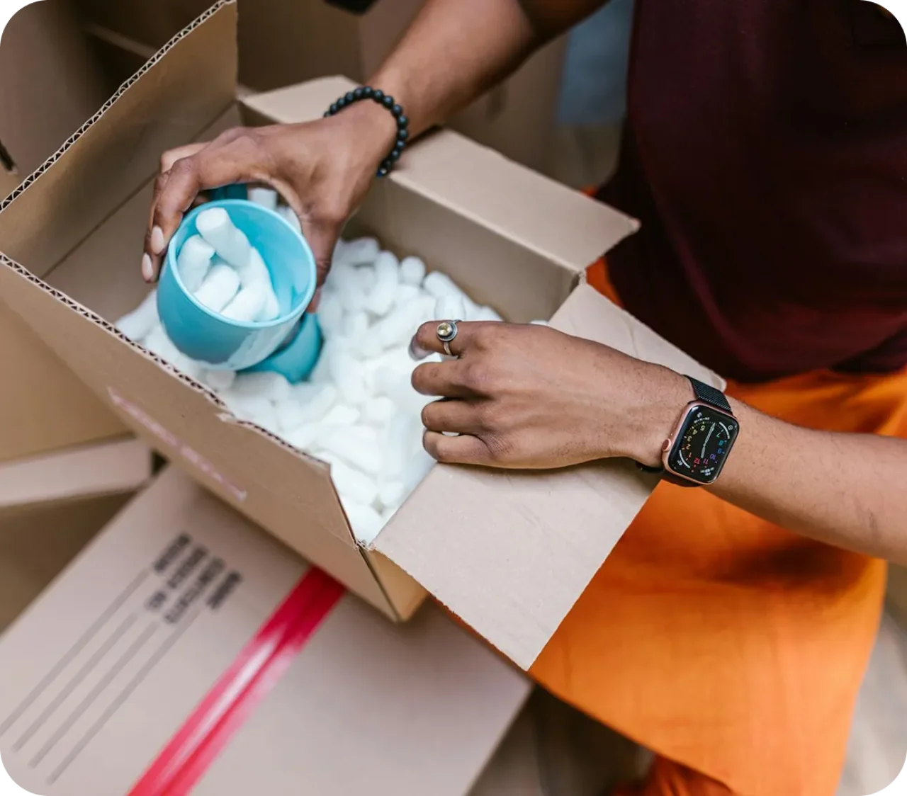 Person Packing Mug In Box With Cushioning